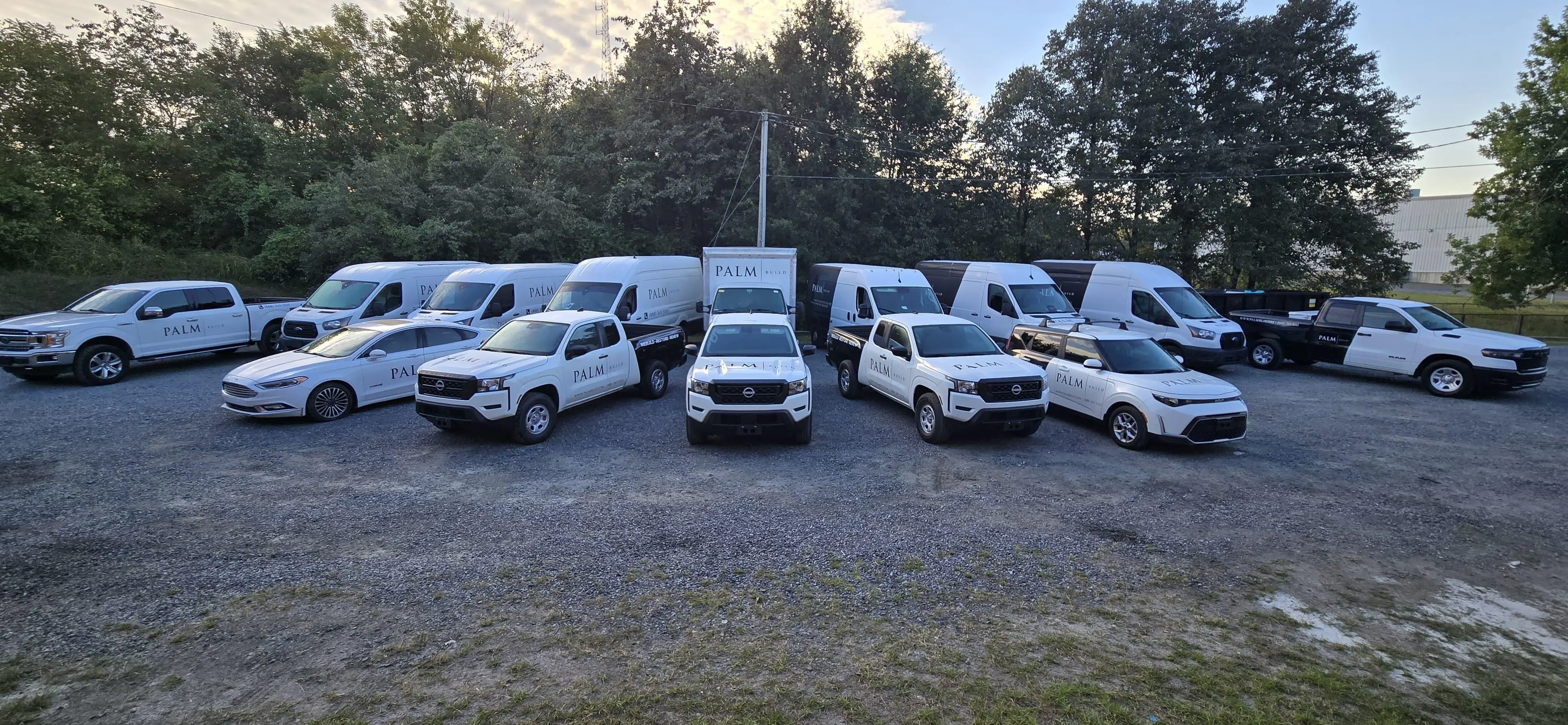 North Carolina team standing with fleet vehicles